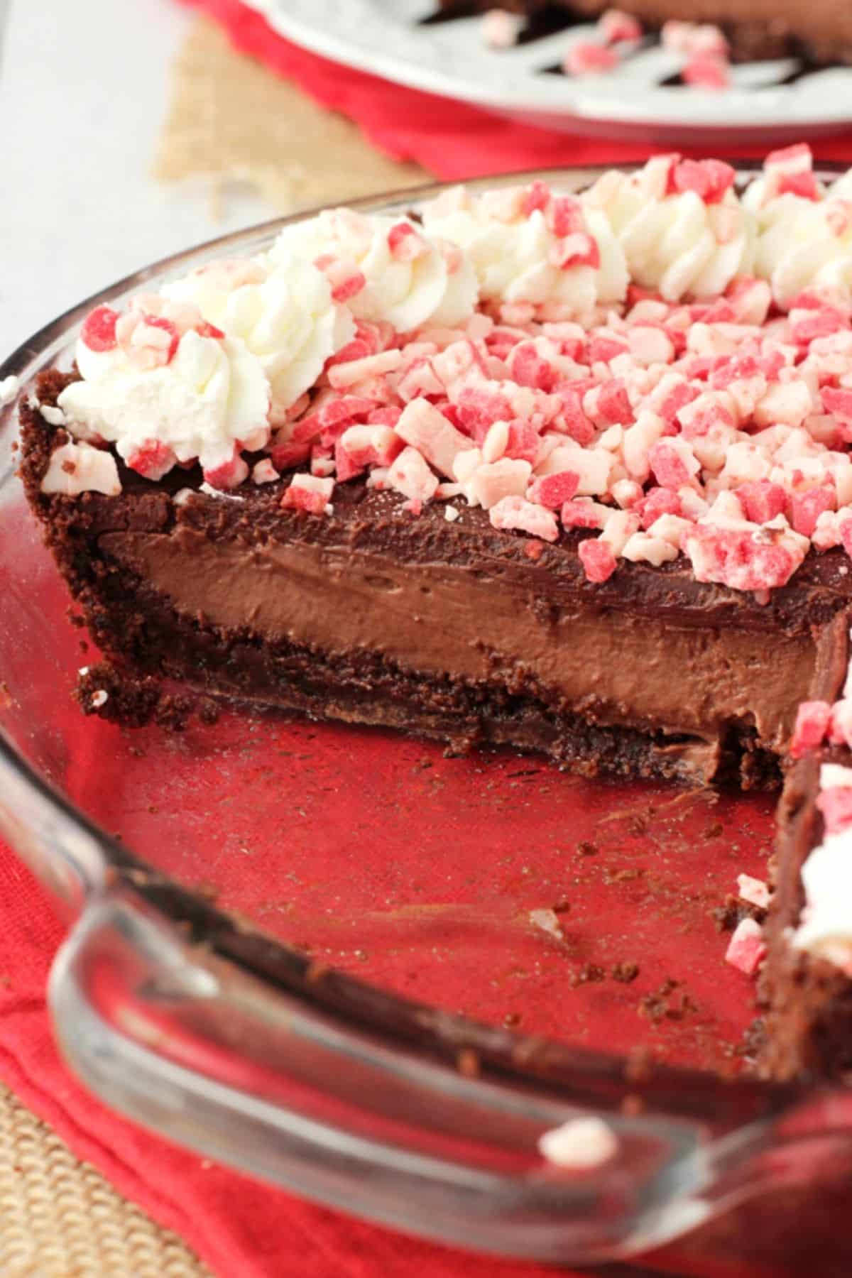 Close up of a Brownie Brittle peppermint chocolate pie with a few slices removed to show layers.