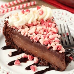 A slice of Brownie Brittle peppermint chocolate pie on a white plate.
