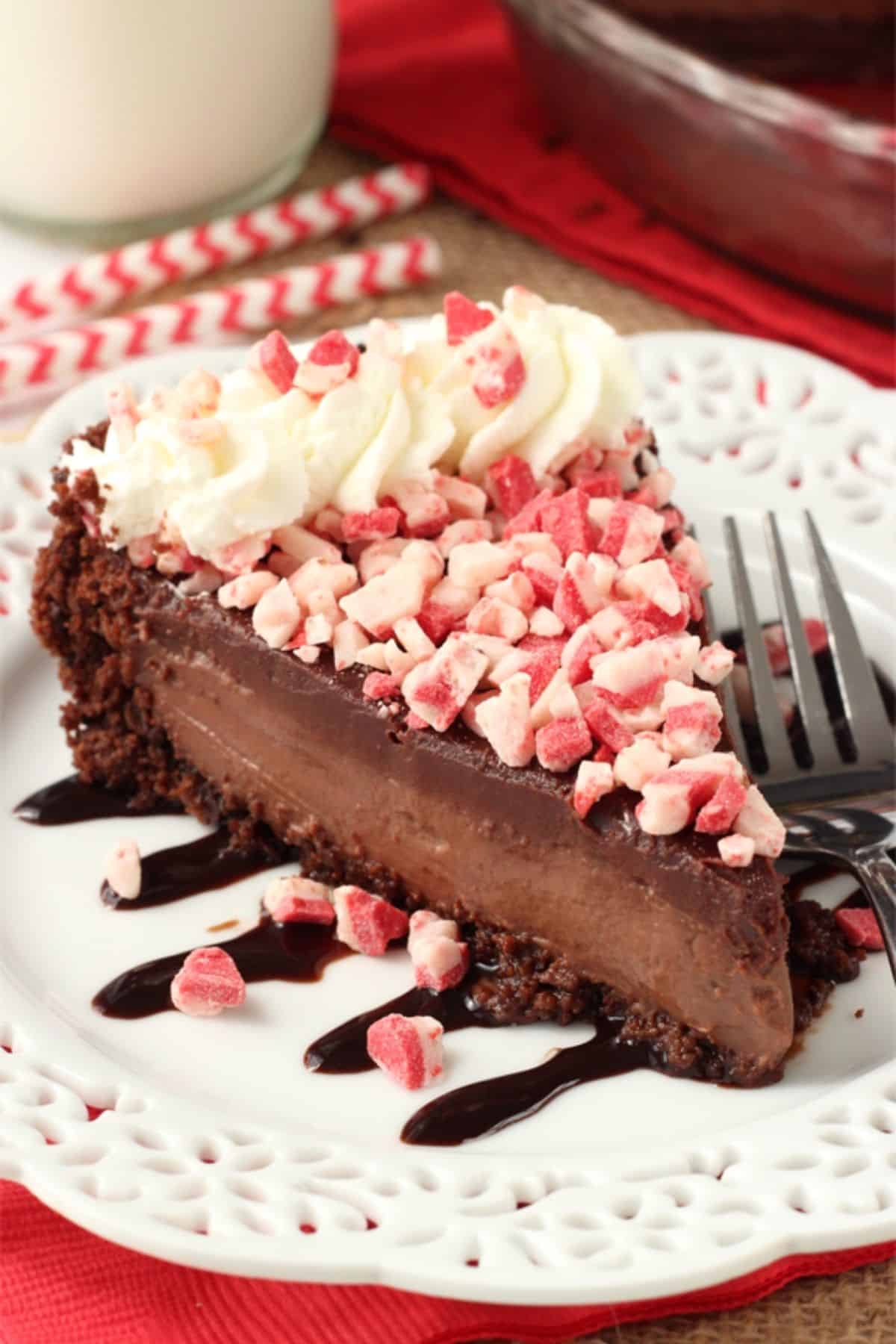 A slice of Brownie Brittle peppermint chocolate pie on a white plate.