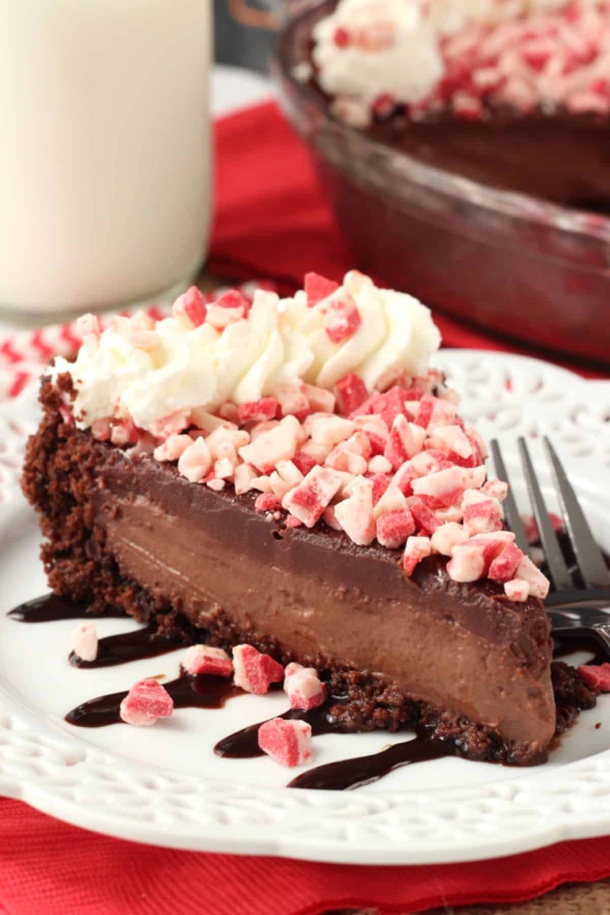 A slice of Brownie Brittle peppermint chocolate pie on a white plate.