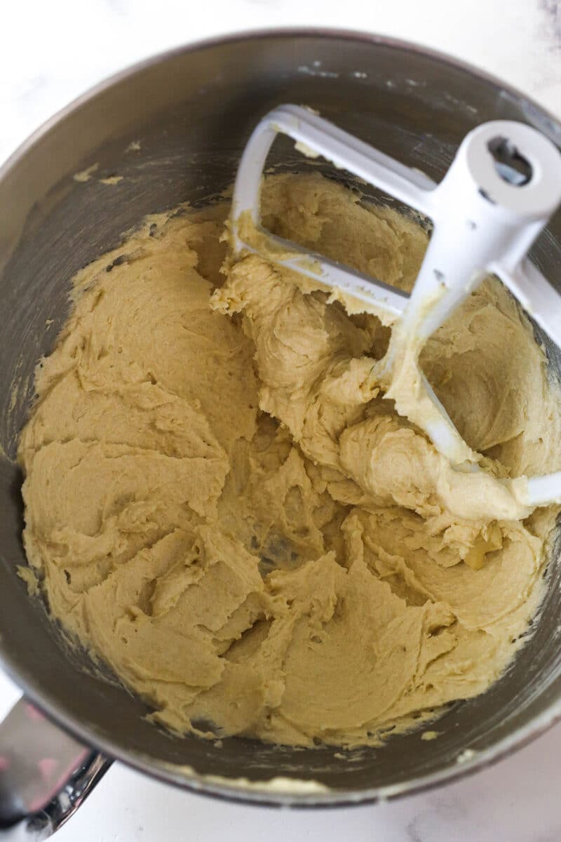 These Caramel Cookie Bars combine gooey caramel and chewy chocolate chip cookies in one perfect dessert. Easy to make! Creaming butter and sugar in a bowl