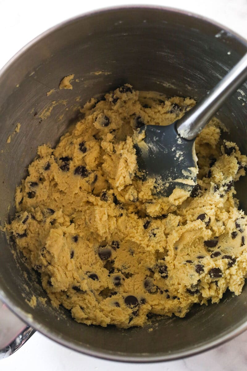 These Caramel Cookie Bars combine gooey caramel and chewy chocolate chip cookies in one perfect dessert. Easy to make! Mixing chocolate chips into cookie dough