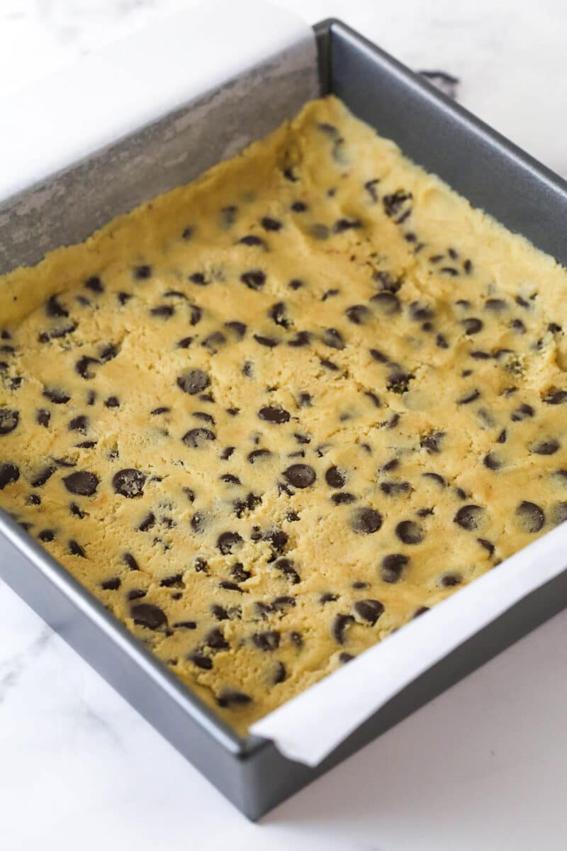 These Caramel Cookie Bars combine gooey caramel and chewy chocolate chip cookies in one perfect dessert. Easy to make! Chocolate chip cookie dough pressed into a square pan