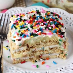 Close up of a slice of Funfetti birthday cake icebox cake on a small white plate.