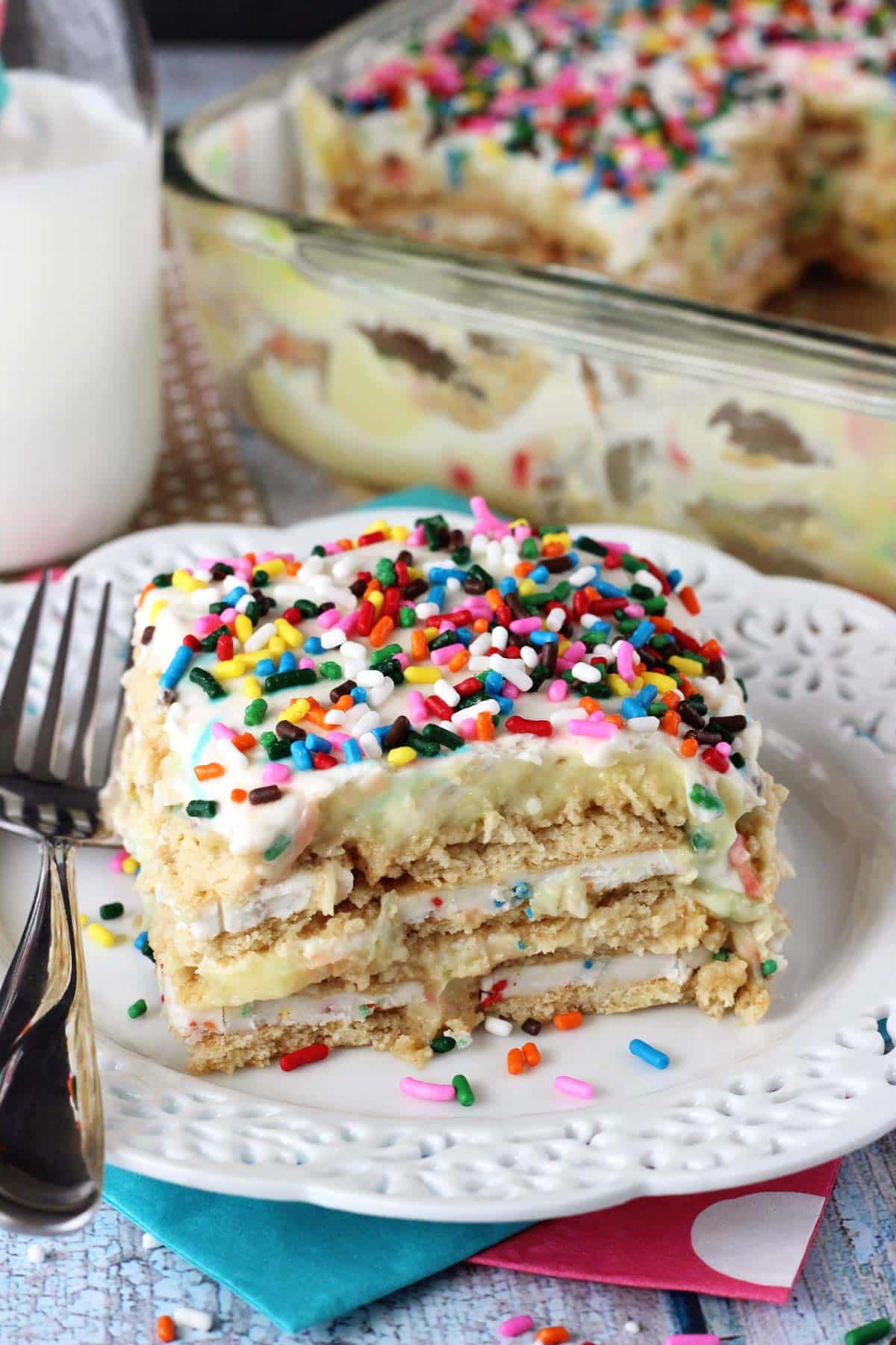 A slice of Funfetti birthday cake icebox cake on a small white plate.
