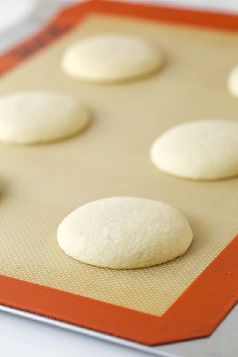 These copycat Lofthouse Cookies are soft and cakey with a melt-in-your-mouth texture and light flavor, just like the ones at the supermarket. Unfrosted Lofthouse sugar cookies on a baking sheet