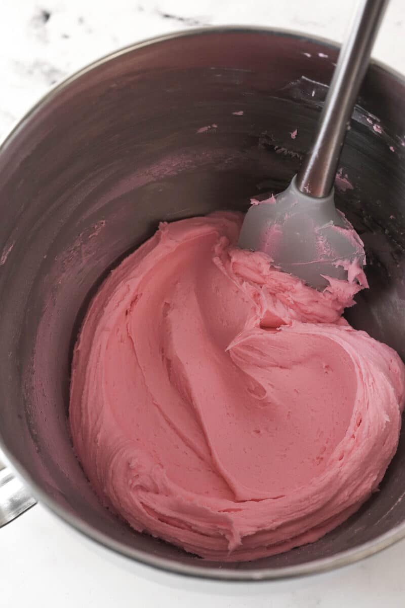 These copycat Lofthouse Cookies are soft and cakey with a melt-in-your-mouth texture and light flavor, just like the ones at the supermarket. Pink buttercream frosting in a bowl