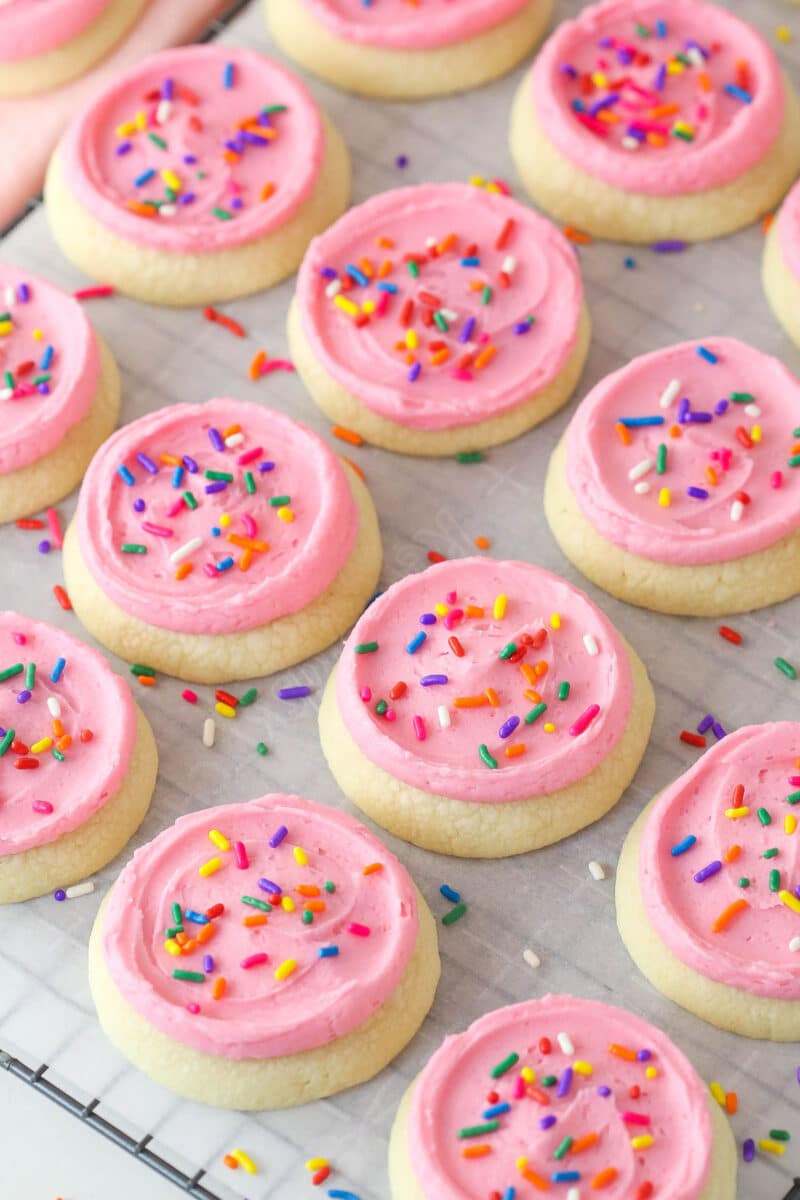 These copycat Lofthouse Cookies are soft and cakey with a melt-in-your-mouth texture and light flavor, just like the ones at the supermarket. Overhead view of Lofthouse cookies on a wire rack