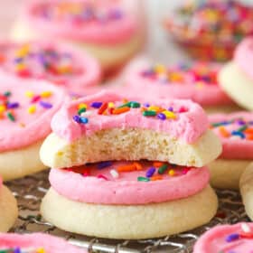 Two copycat Lofthouse cookies stacked on a wire rack, one with a bite missing