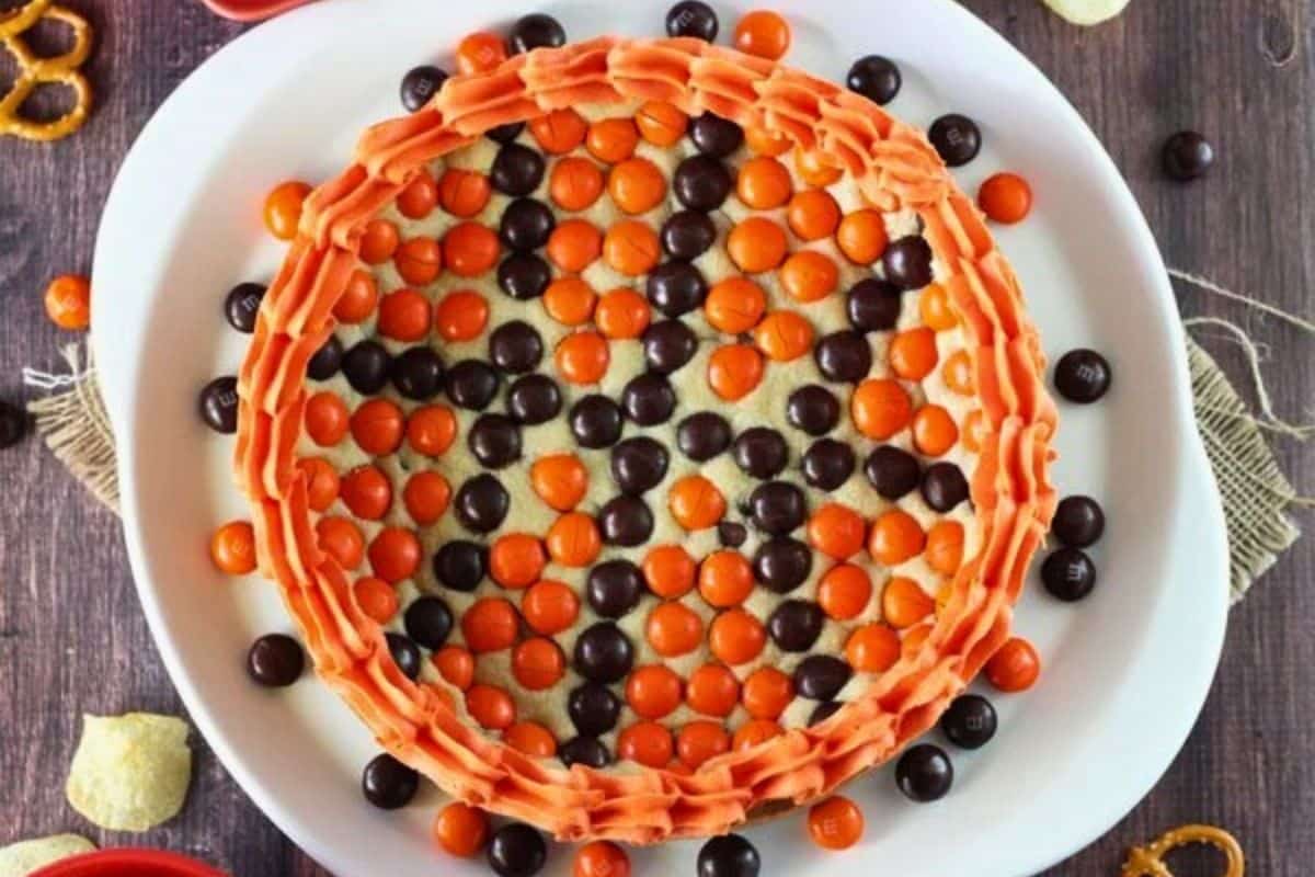Top view of an M&M basketball cake on a white platter.