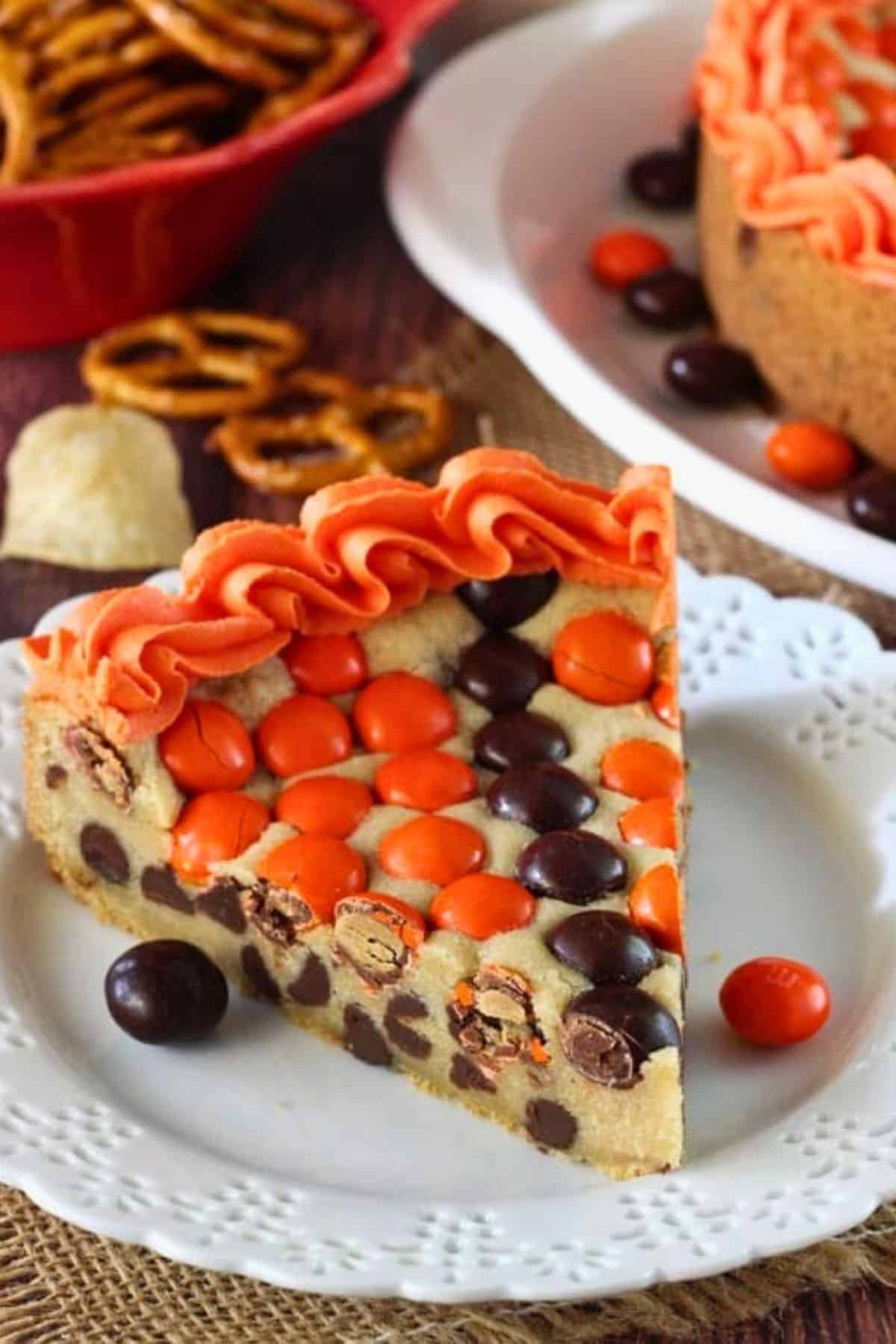 Close up of a slice of M&M basketball cake on a small white plate.