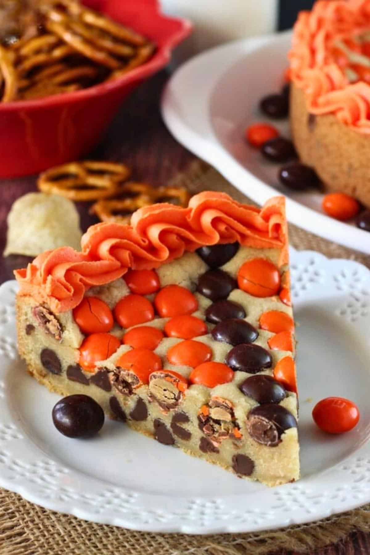 A slice of M&M basketball cake on a small white plate.