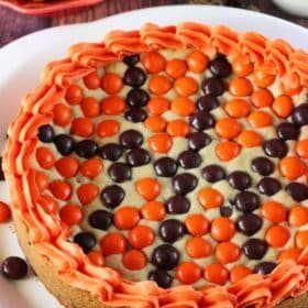 Close up of an M&M basketball cake on a white platter.