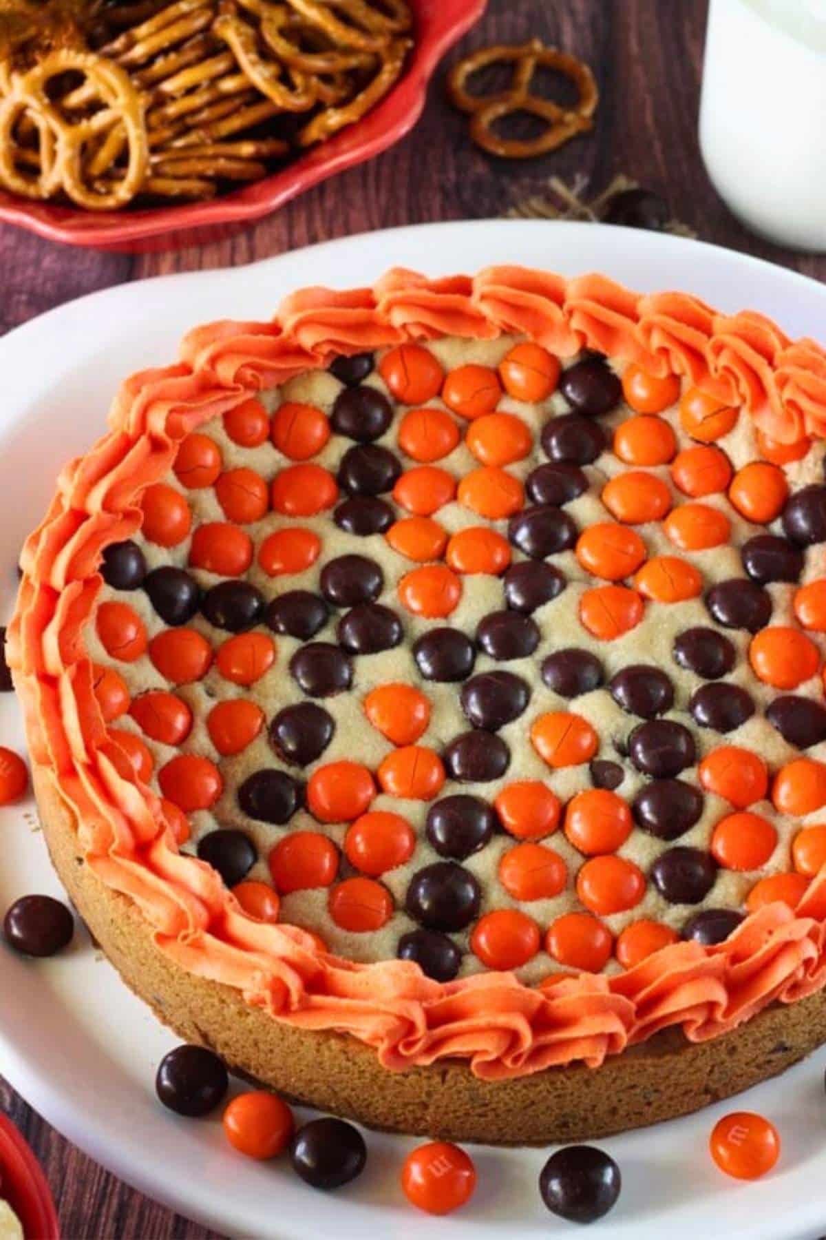 Close up of an M&M basketball cake on a white platter.