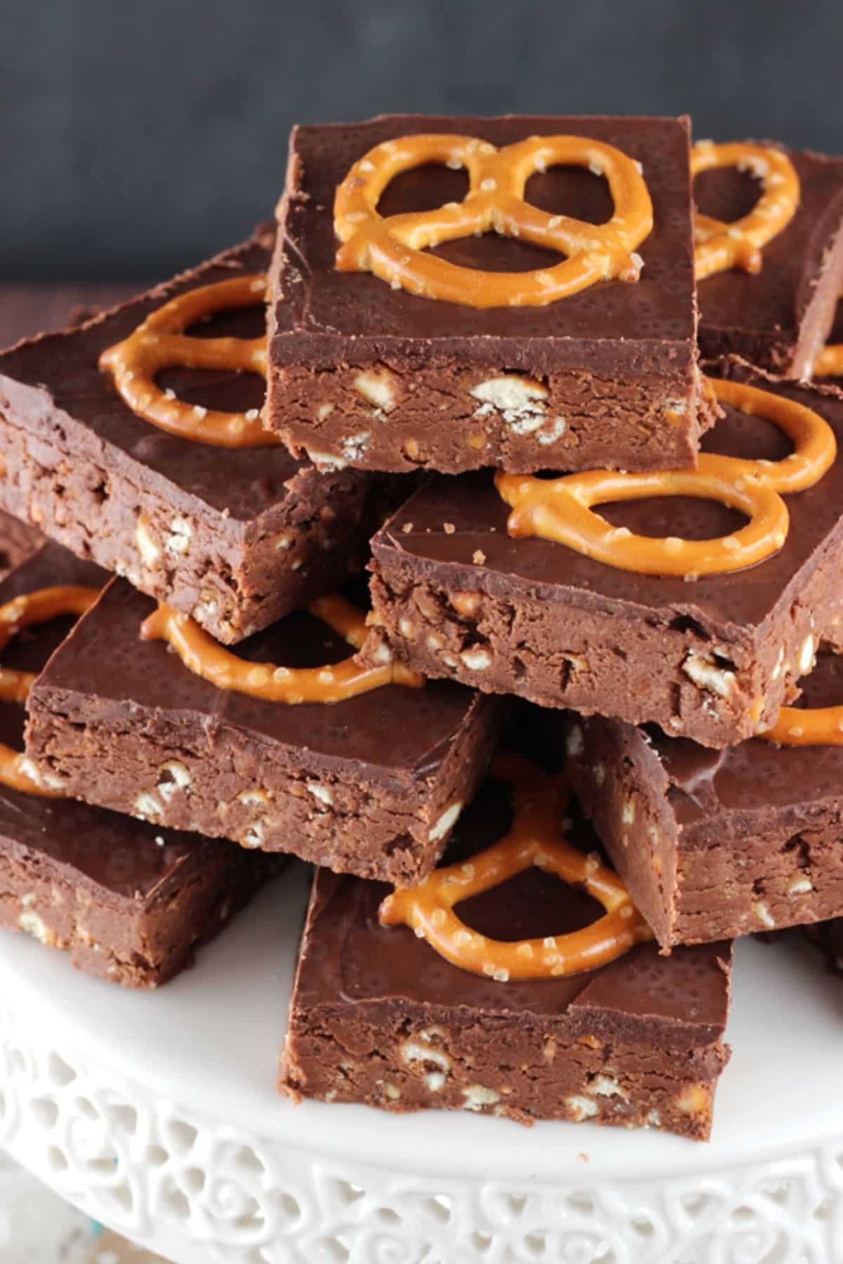 Overhead view of no bake Nutella pretzel bars piled on a white cake stand.