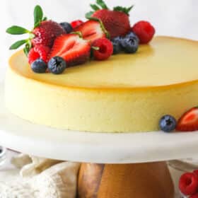 Ricotta cheesecake on a serving platter topped with fresh fruit