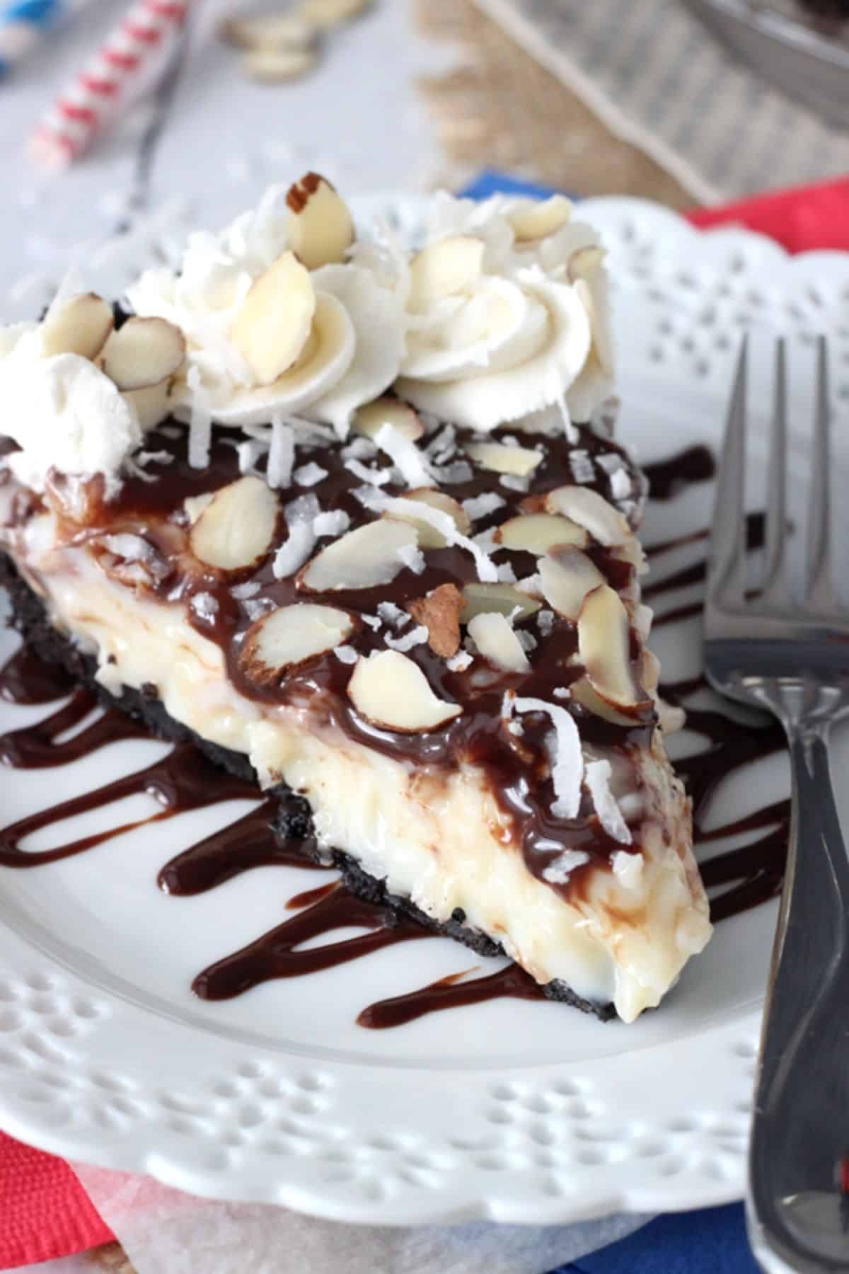 A slice of almond joy pie on a white plate.