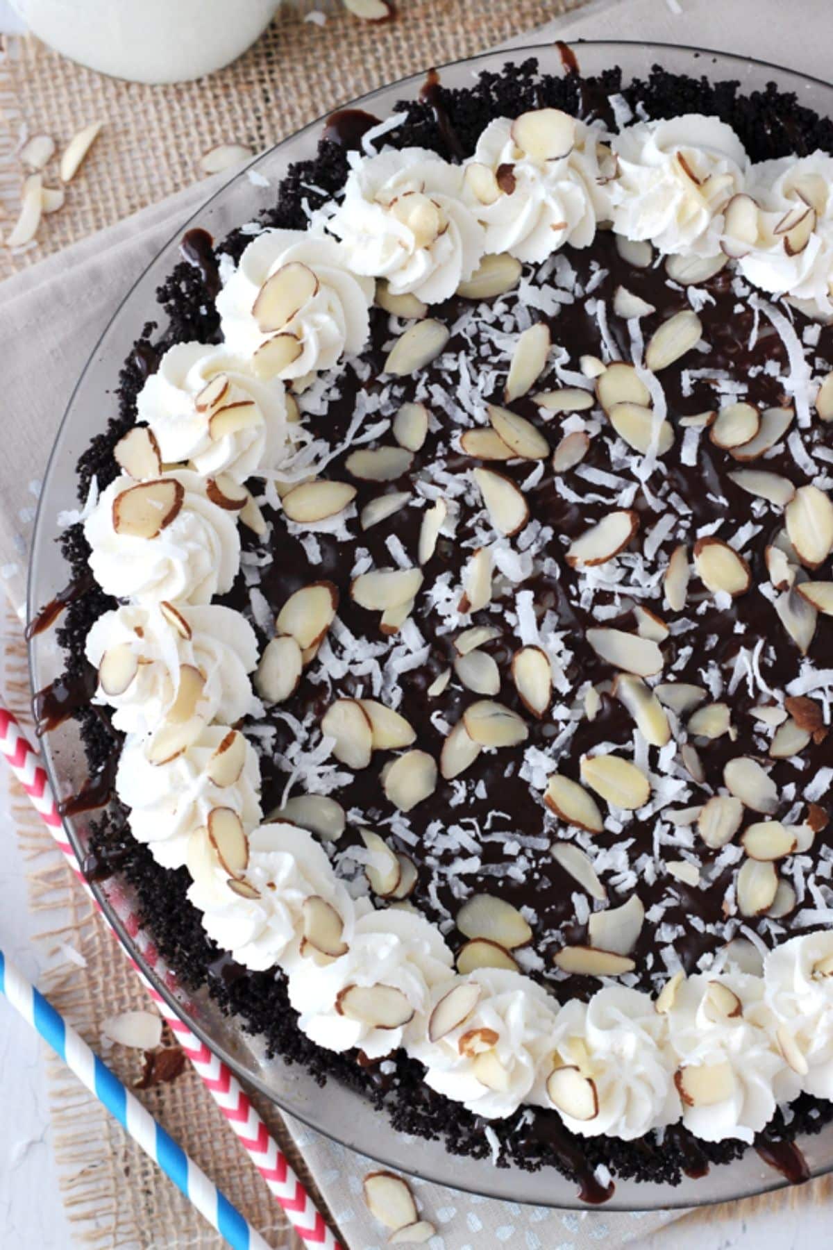 Top view of an almond joy pie on a clear cake plate.