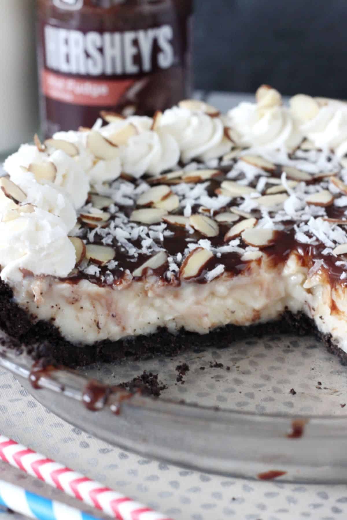 An almond joy pie with a few slices removed to show the center.