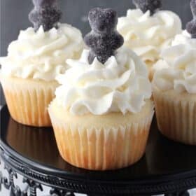 Close up of anise cupcakes on a black cake stand.