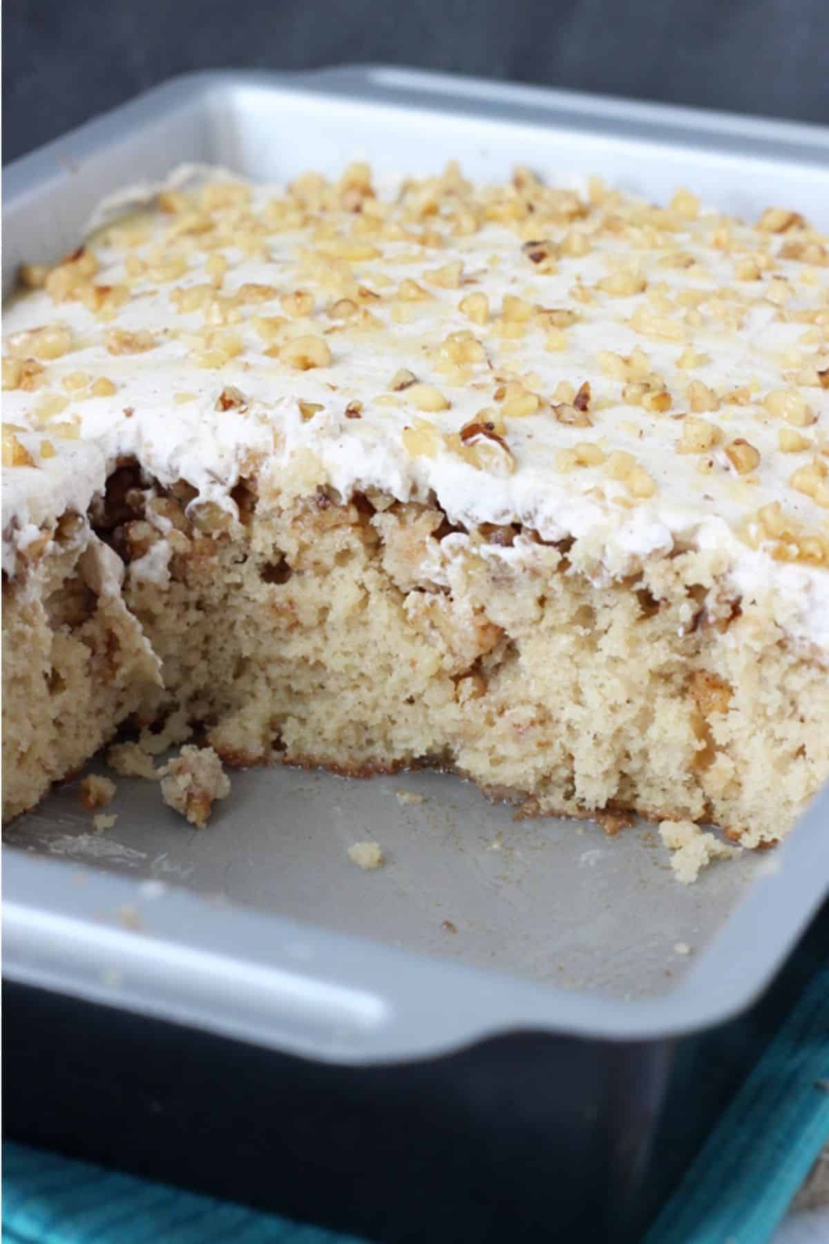 A pan of baklava poke cake with several slices removed to show inside.