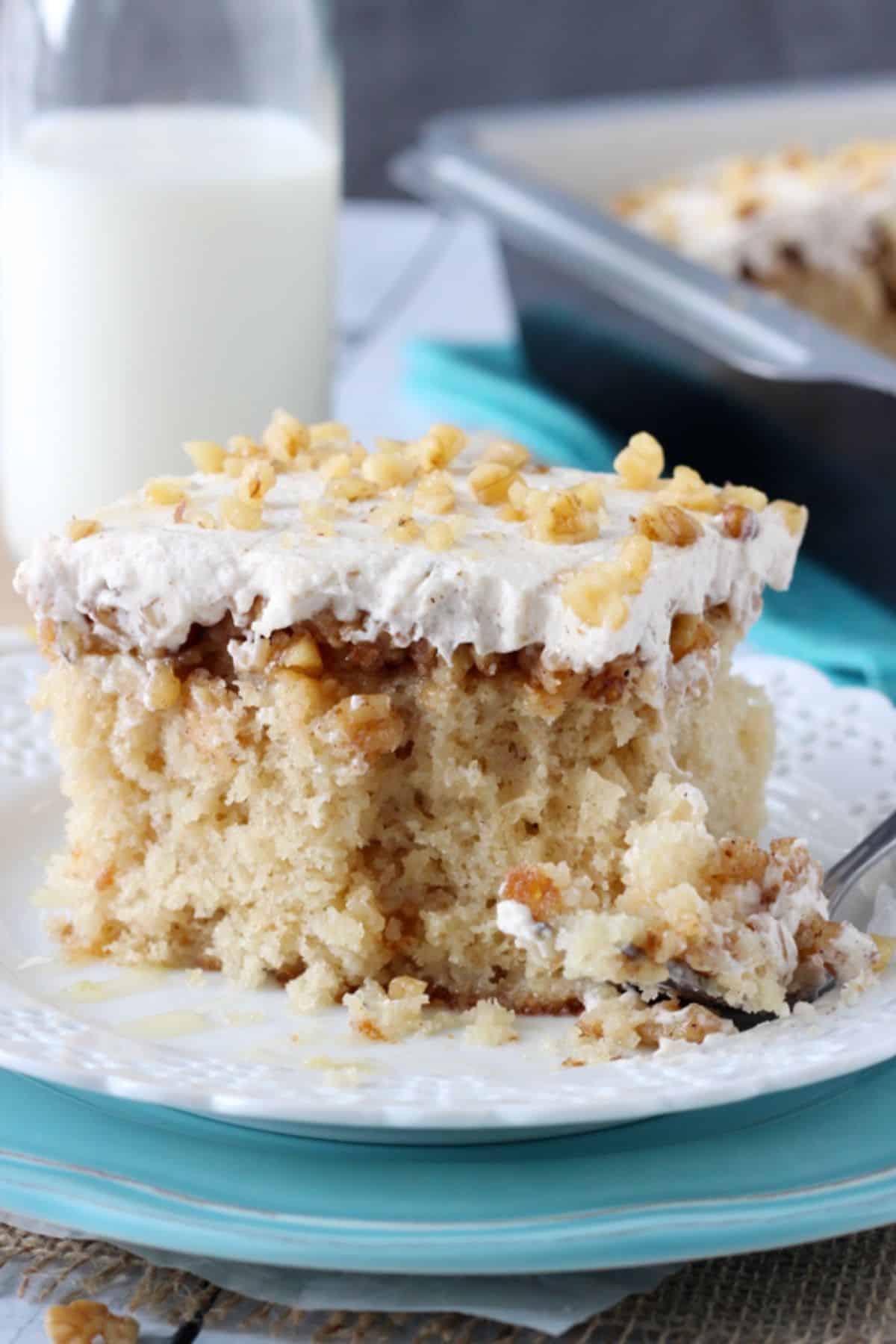 Close up of a slice of baklava poke cake with a bite removed on a fork.