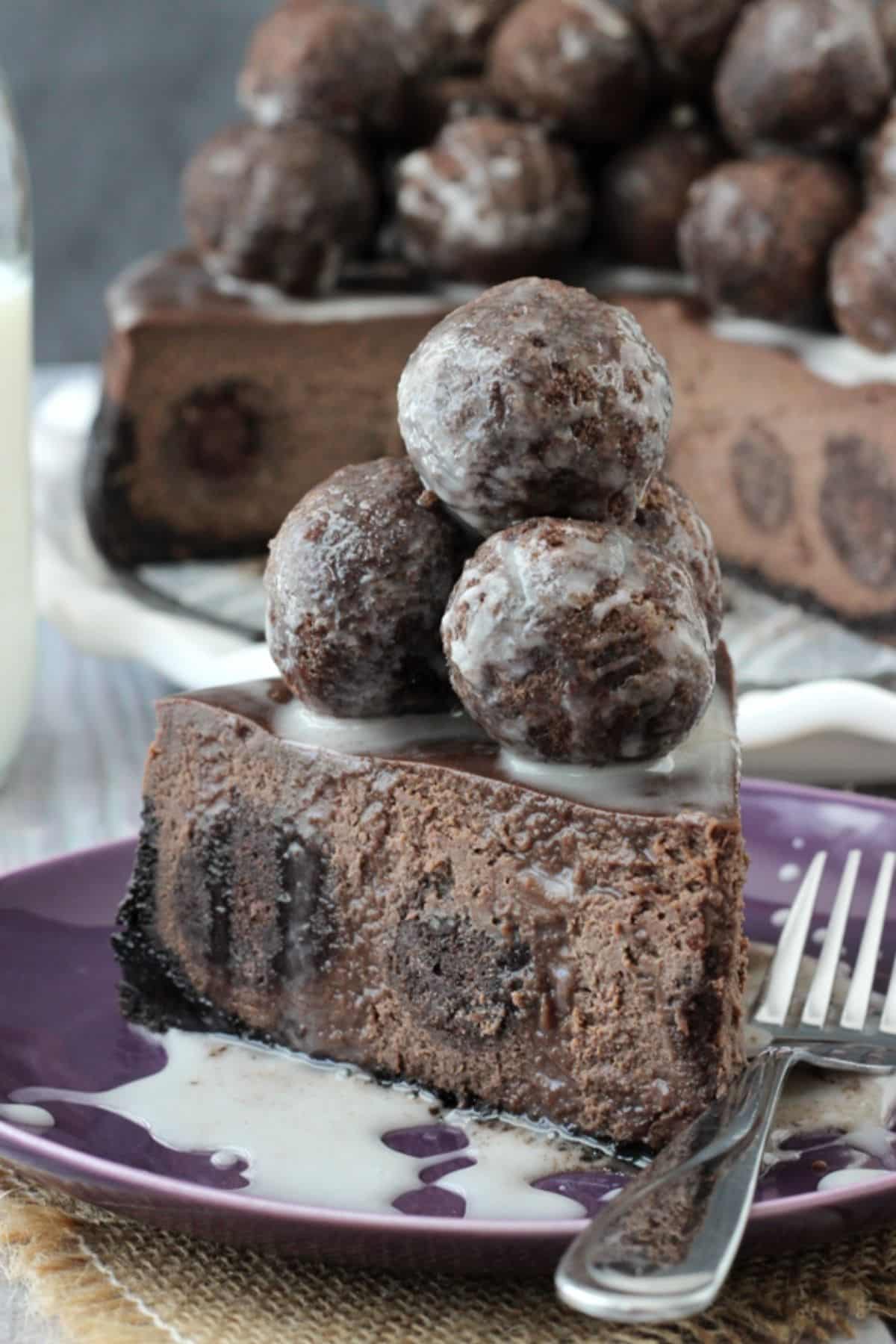 A slice of chocolate donut hole cheesecake piled high with donut holes.