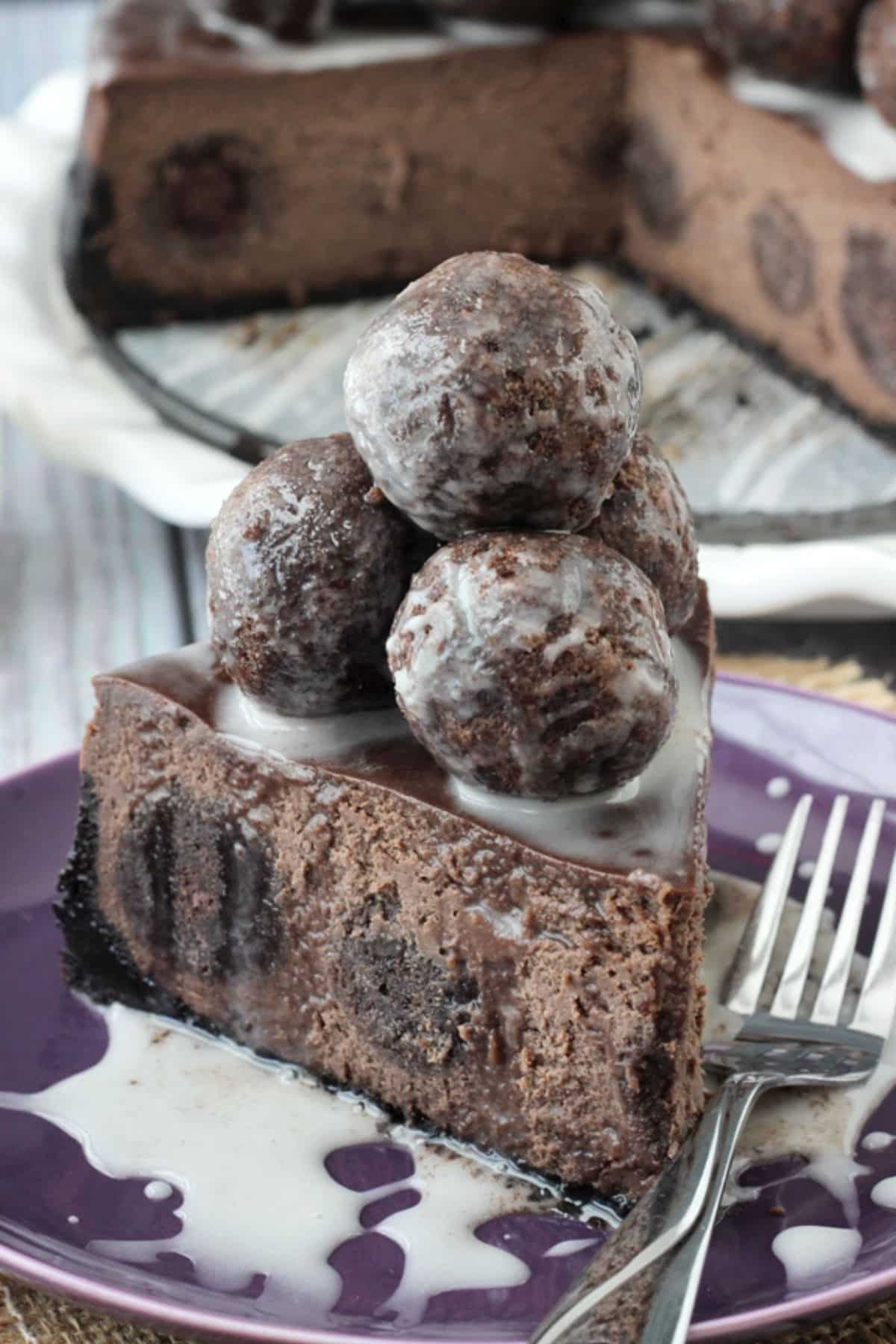 A slice of chocolate donut hole cheesecake piled with donut holes.