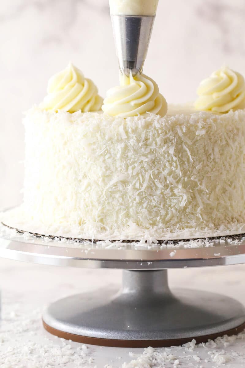 piping buttercream swirl onto the top of the cake