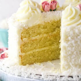 coconut cake with a slice removed to see the inside