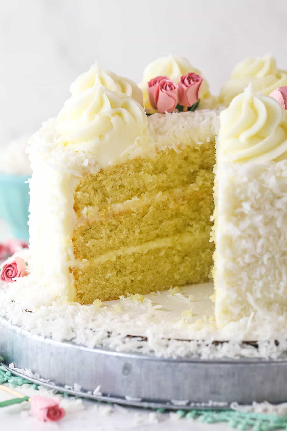 coconut cake with a slice removed to see the inside