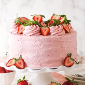 Decorated fresh strawberry cake on a cake stand
