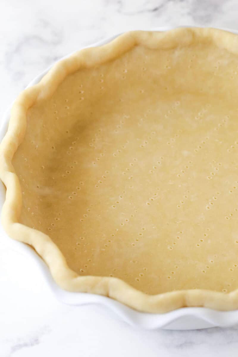 This classic lemon meringue pie features a tart lemon filling in a buttery crust topped with a light but stable meringue. Pie crust dough in a pie pan