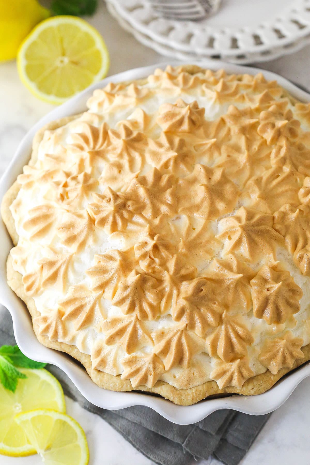 This classic lemon meringue pie features a tart lemon filling in a buttery crust topped with a light but stable meringue. Overhead view of a lemon meringue pie