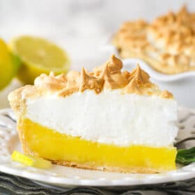 Side view of a slice of lemon meringue pie on a plate