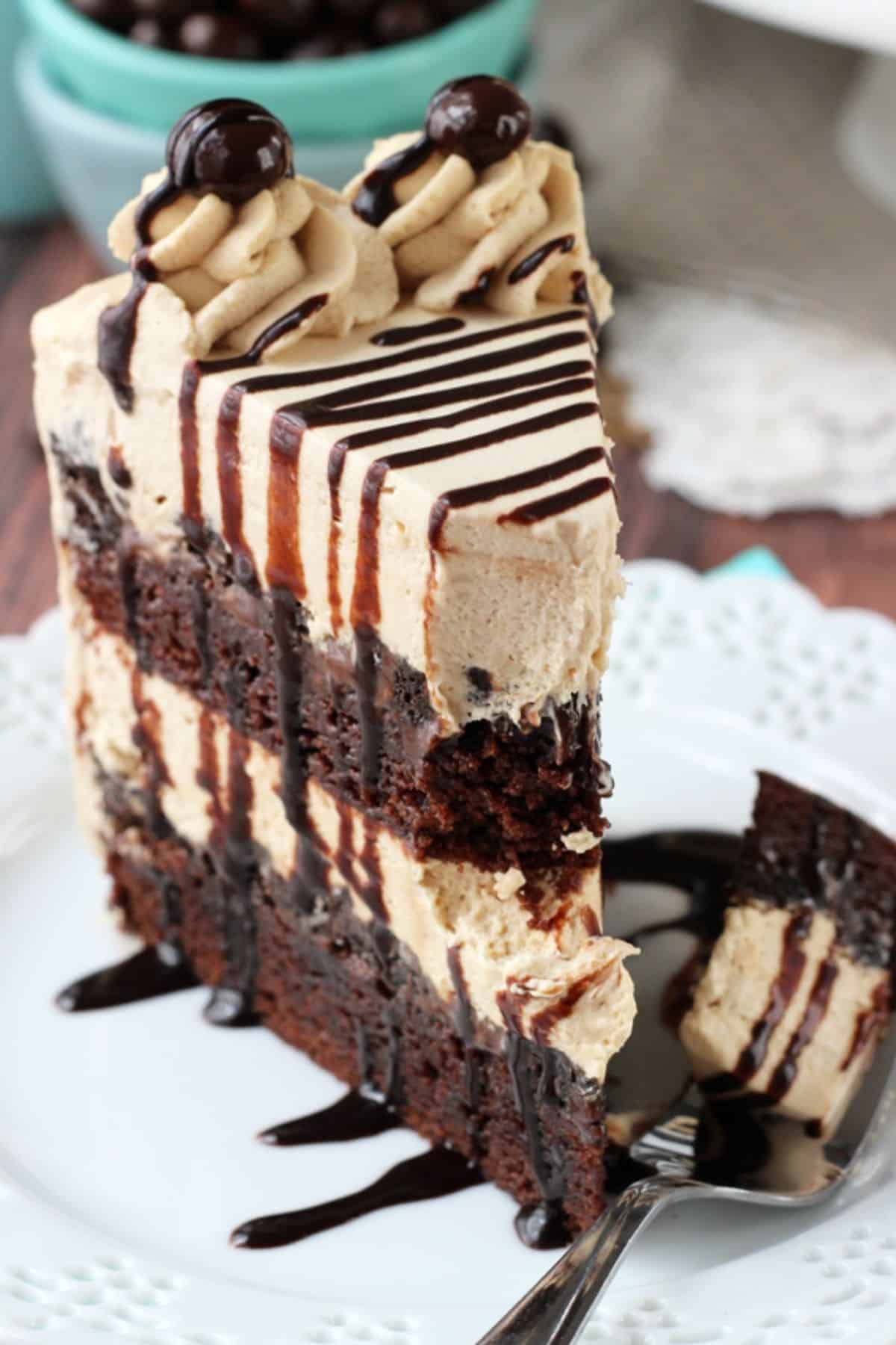 Close up of a slice of mocha brownie ice cream cake with a bite removed on a fork.