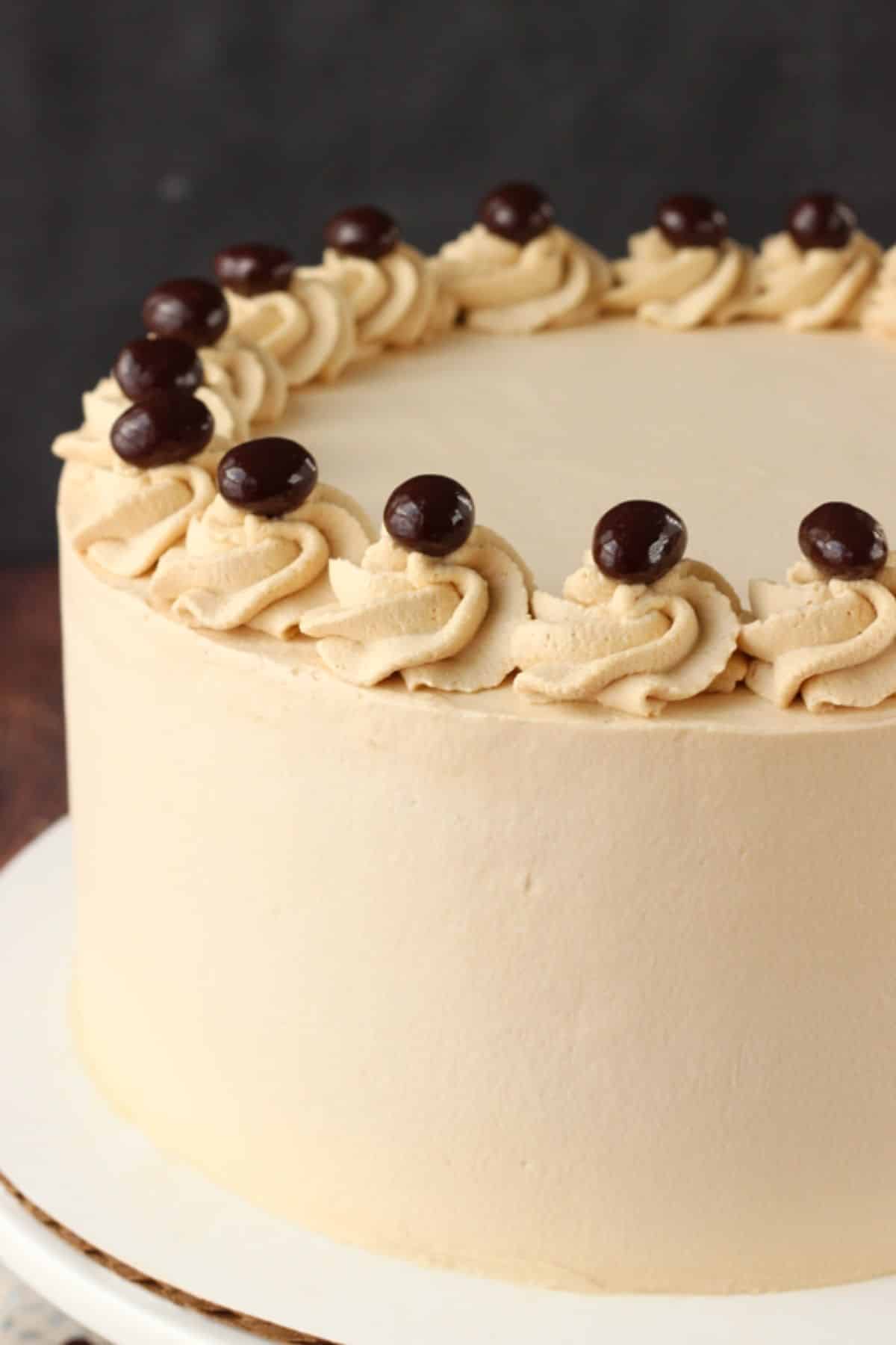 Close up of the side of a frosted mocha brownie ice cream cake.