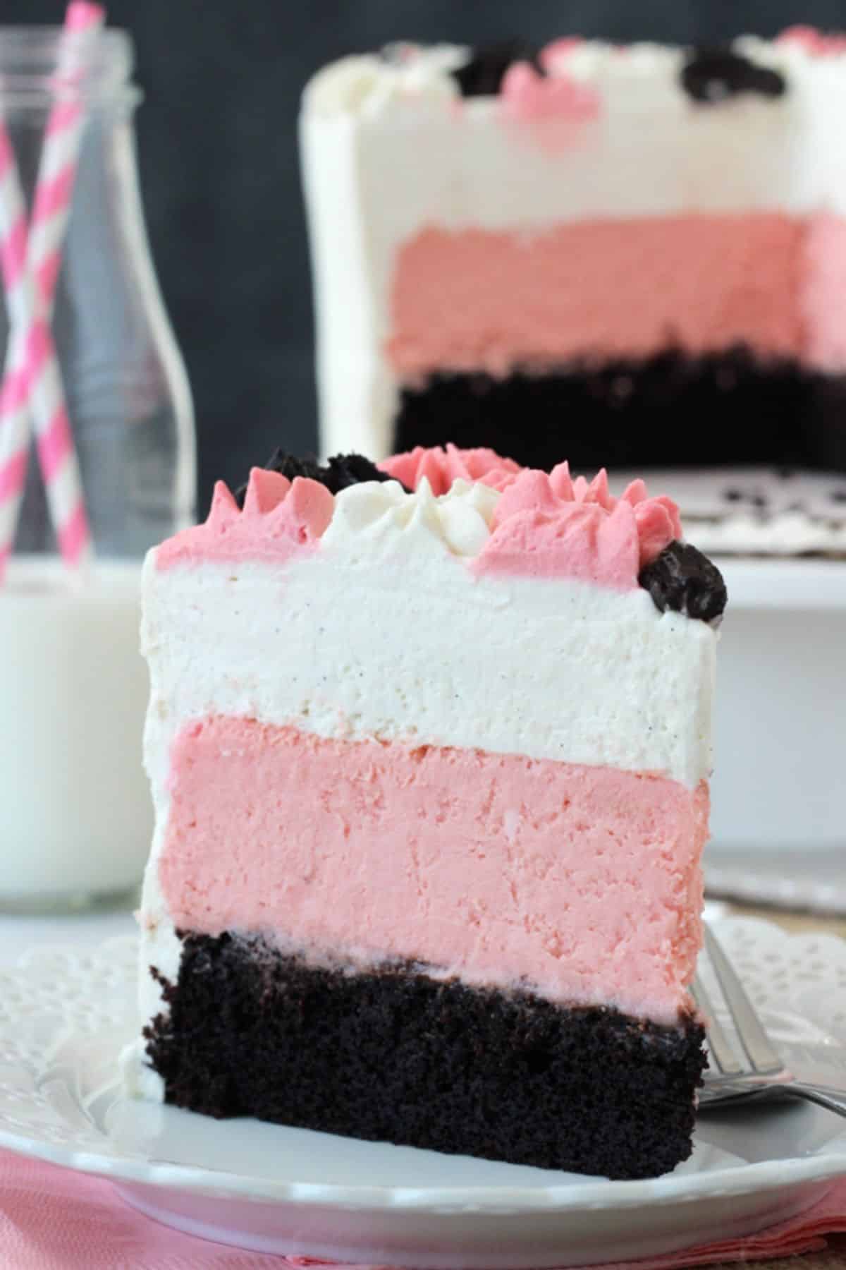 A slice of neapolitan millionaire cake on a white plate.