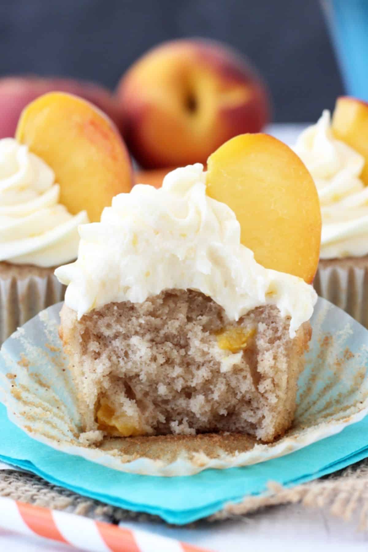 An unwrapped peach pie cupcake with a few bites removed to see inside.