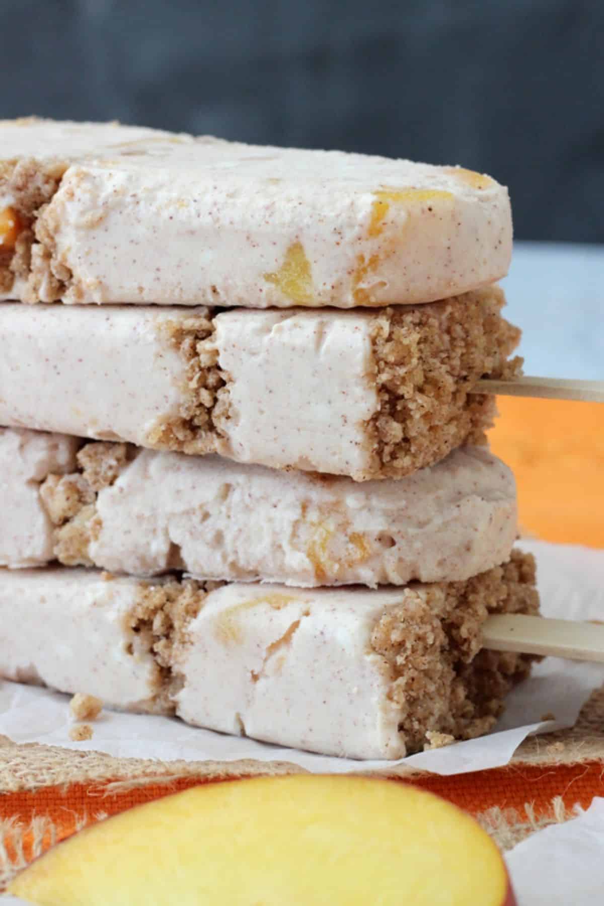 Close up of a stack of 4 peach streusel popsicles stacked one on top of the other.