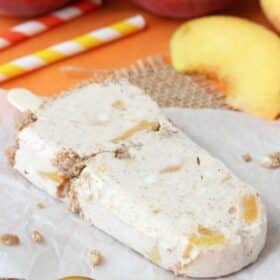 A peach streusel popsicle laying on a piece of parchment.