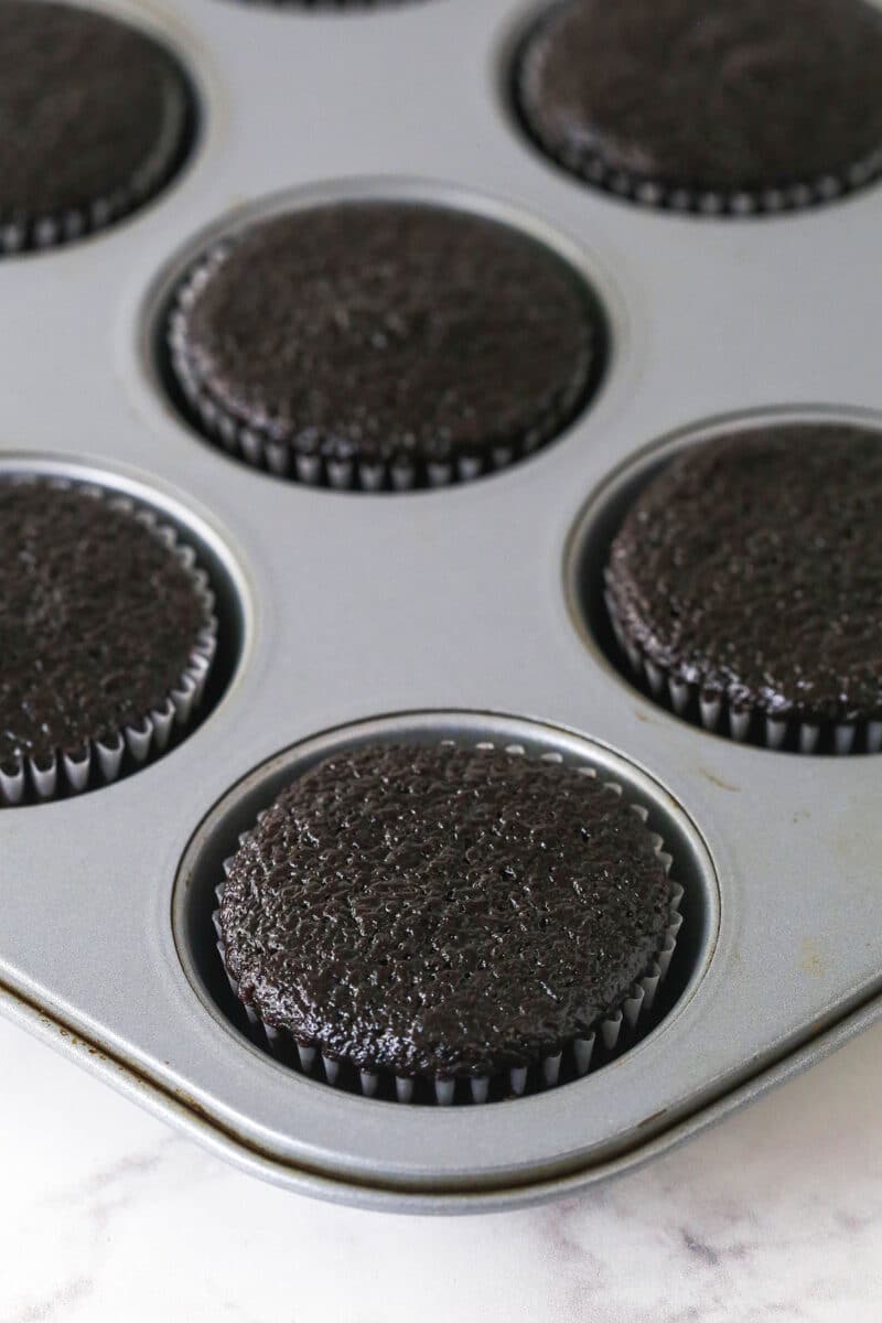These peanut butter chocolate cupcakes are all about the classic flavor combo, with peanut butter buttercream on moist cupcakes. Baked chocolate cupcakes in a cupcake tin