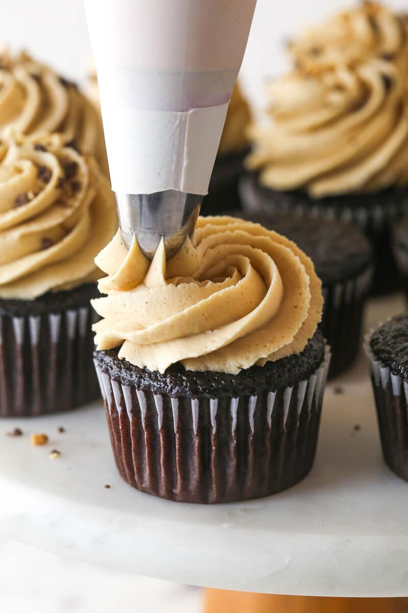 These peanut butter chocolate cupcakes are all about the classic flavor combo, with peanut butter buttercream on moist cupcakes. Piping peanut butter buttercream on top of chocolate cupcakes
