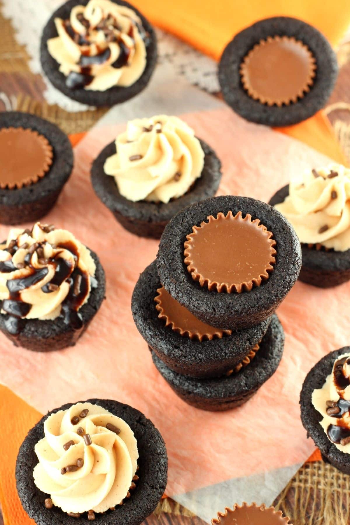Top view of a stack of Reese's chocolate cookie cups with more surrounding the stack.