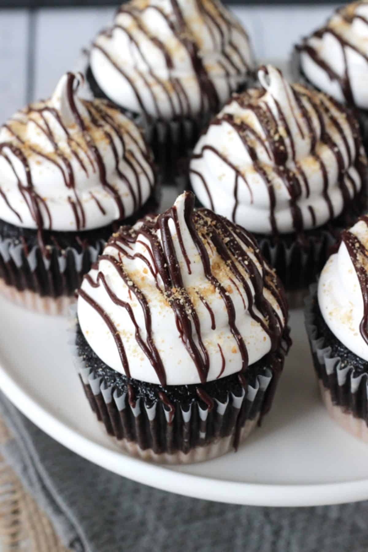 Side view of S'mores Cupcakes on a white plate.