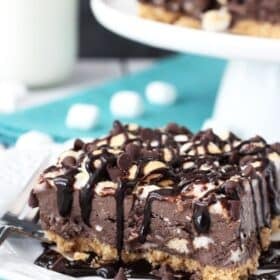 A slice of s'mores ice cream bars on a small white plate.