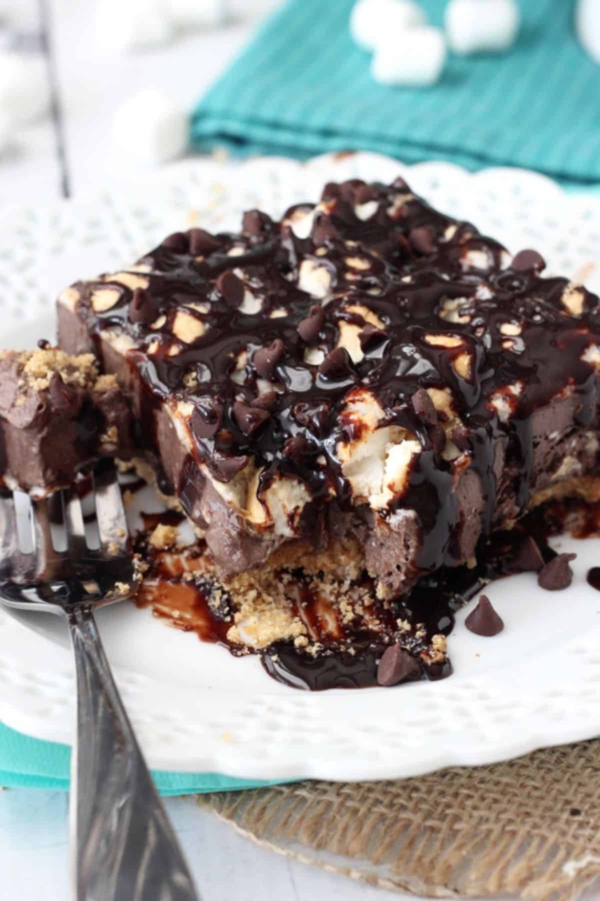Close up of a slice of s'mores ice cream bars with a bite removed on a fork.