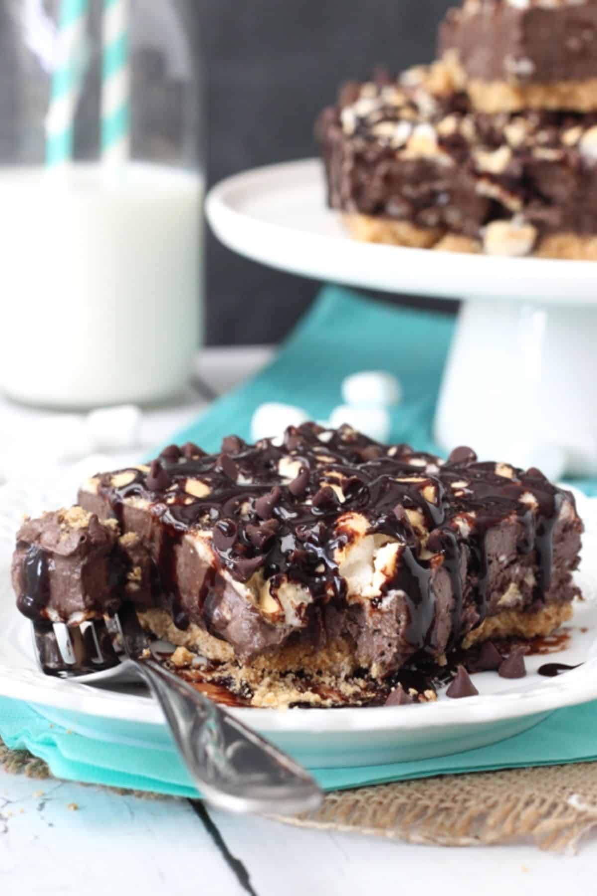 A slice of s'mores ice cream bars with a bite removed on a fork.