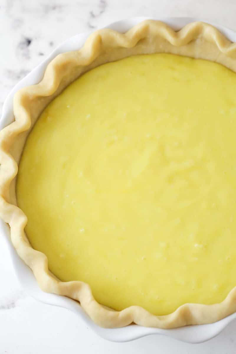 With a thick, creamy custard in a flaky, buttery pie crust, this coconut custard pie delivers just the right amount of coconut flavor. Overhead view of an unbaked coconut custard pie