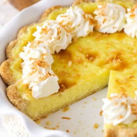 A coconut custard pie with a slice missing